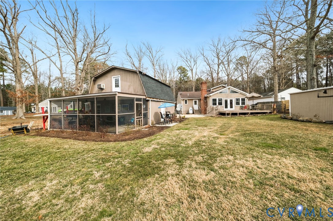 844 Monarch Shores Road Kilmarnock, VA 22482 - Photo 32 of 54 a view of a house with a yard and sitting area