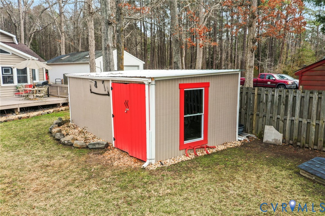 844 Monarch Shores Road Kilmarnock, VA 22482 - Photo 34 of 54 a view of a chairs and table in backyard