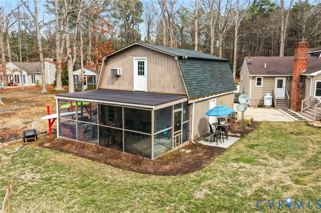 844 Monarch Shores Road Kilmarnock, VA 22482 - Photo 34 of 54 a view of a house with a yard chairs and iron fence