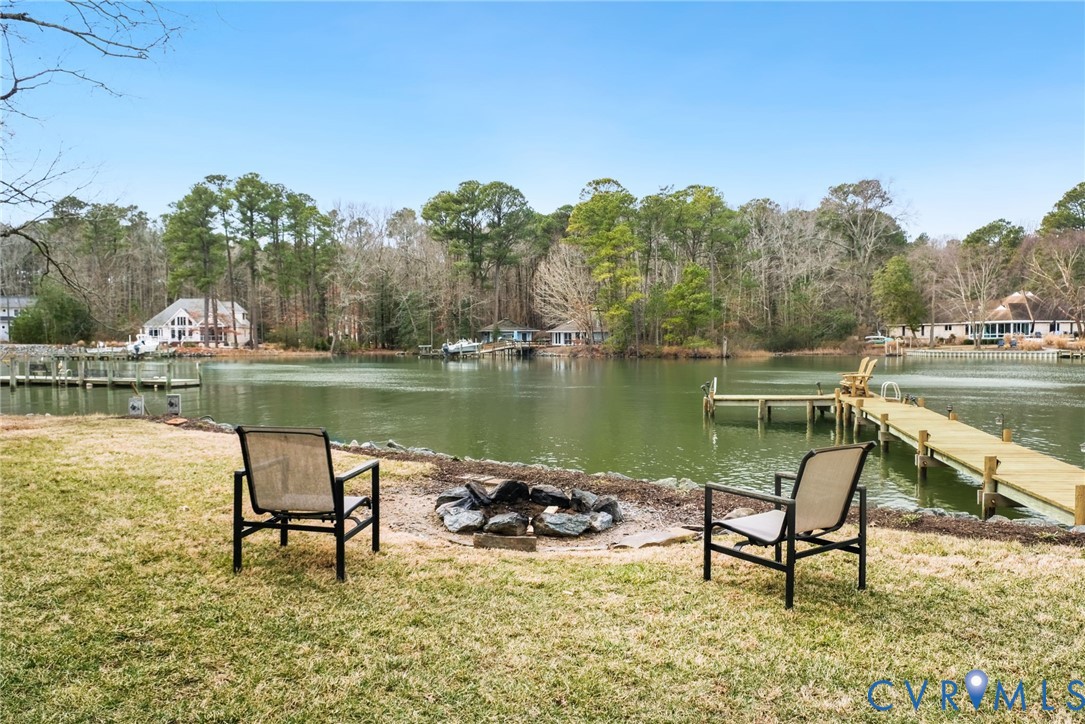 844 Monarch Shores Road Kilmarnock, VA 22482 - Photo 40 of 54 a view of a lake with table and chairs
