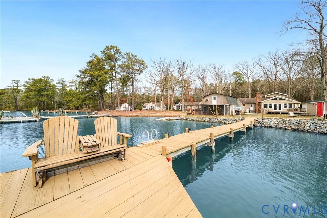 844 Monarch Shores Road Kilmarnock, VA 22482 - Photo 46 of 54 a view of swimming pool with lake and trees in the background