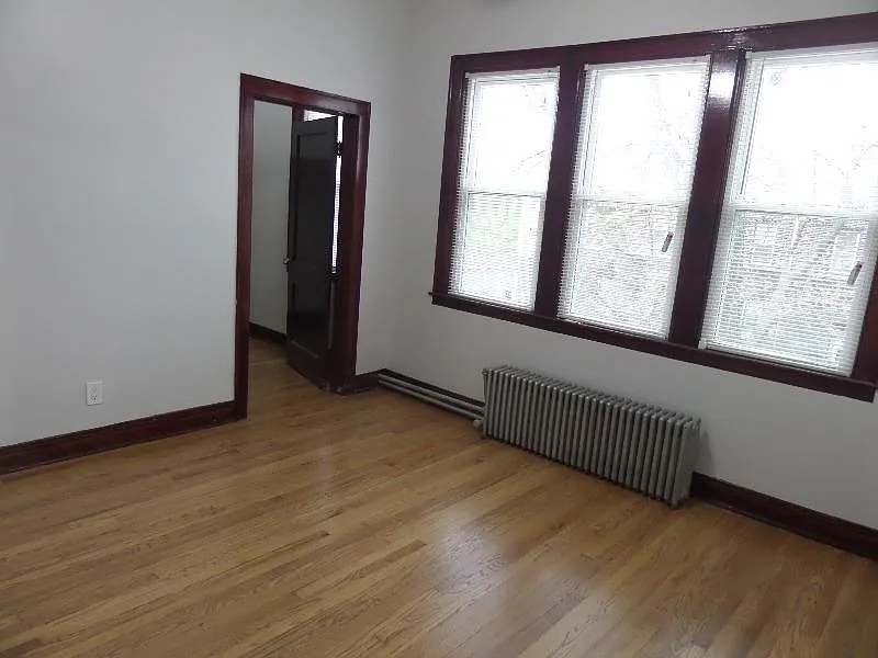 2836 East 84th Street Chicago, IL 60617 - Photo 6 of 7 an empty room with wooden floor and windows