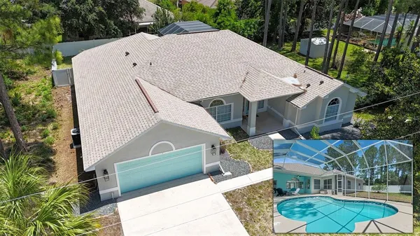 a view of a white building with swimming pool