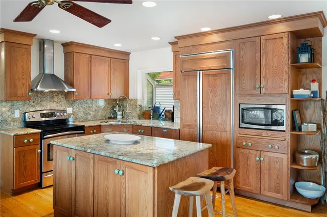 a kitchen with a stove a sink and a refrigerator