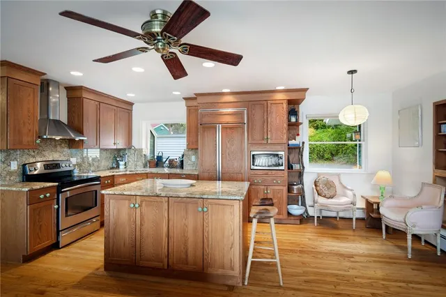 a kitchen with a stove a refrigerator and wooden cabinets