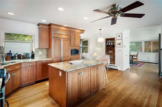 a kitchen with stainless steel appliances granite countertop wooden floors and sink