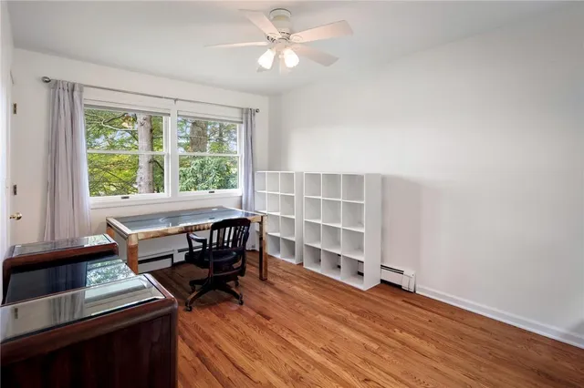 a view of a workspace with furniture and a window