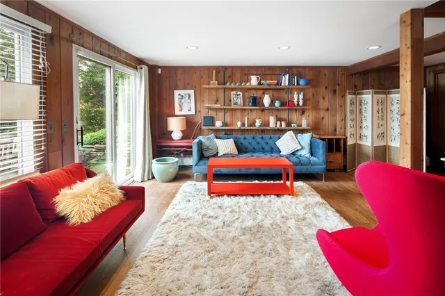 a bedroom with furniture and a large window