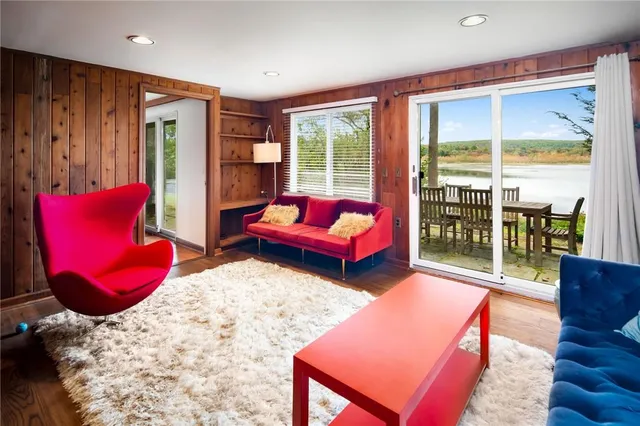 a bedroom with furniture and a large window