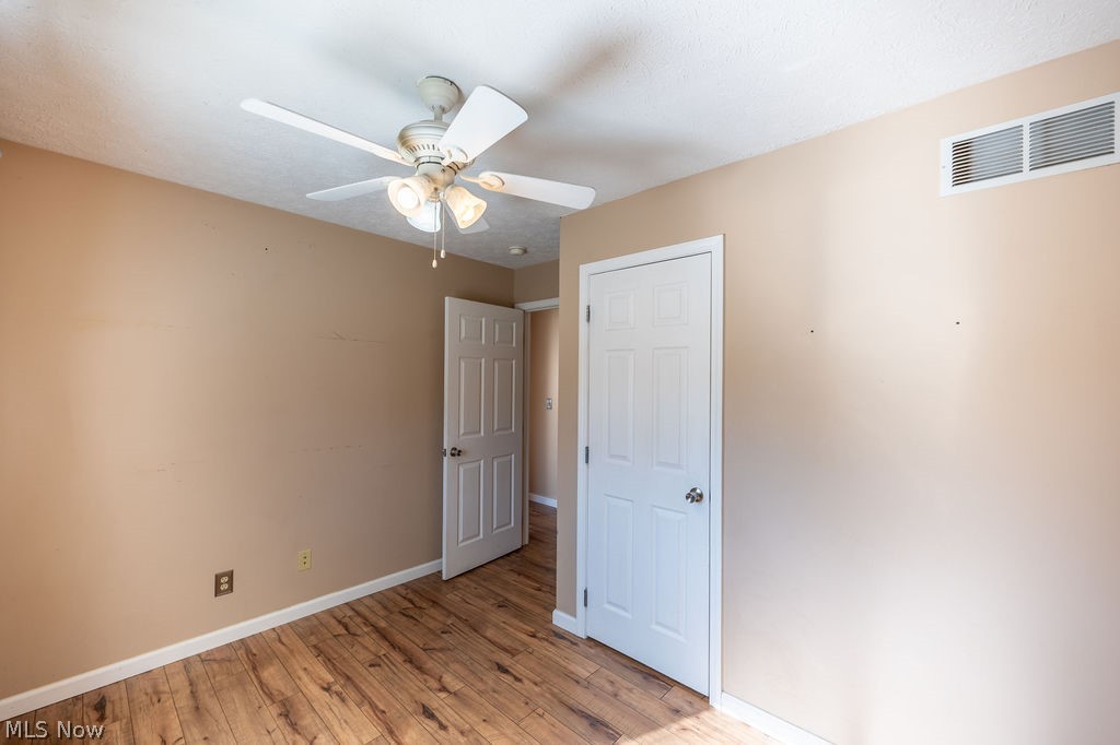 3601 River Road Vienna, WV 26105 - Photo 20 of 40 Empty room with light wood-style flooring and a ceiling fan