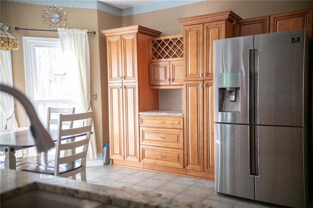 2932 Sunset View Circle Suwanee, GA 30024 - Photo 16 of 44 a view of kitchen with stainless steel appliances wooden floor and staircase