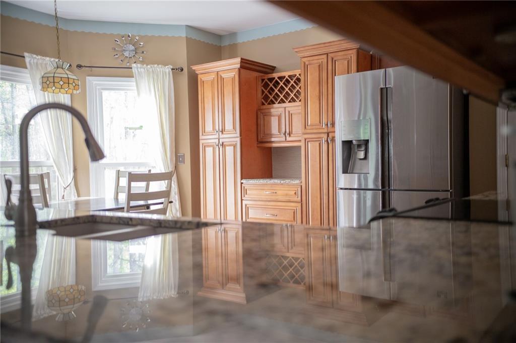 2932 Sunset View Circle Suwanee, GA 30024 - Photo 17 of 44 a kitchen with stainless steel appliances granite countertop a refrigerator a stove and a sink with wooden floor