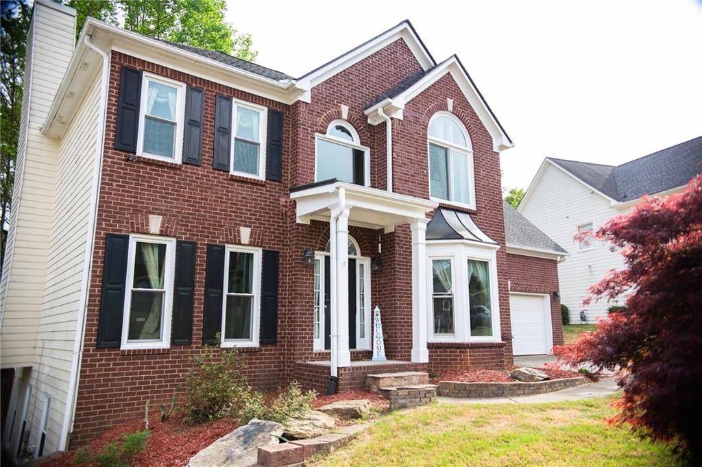 2932 Sunset View Circle Suwanee, GA 30024 - Photo 2 of 44 a front view of a house with a yard