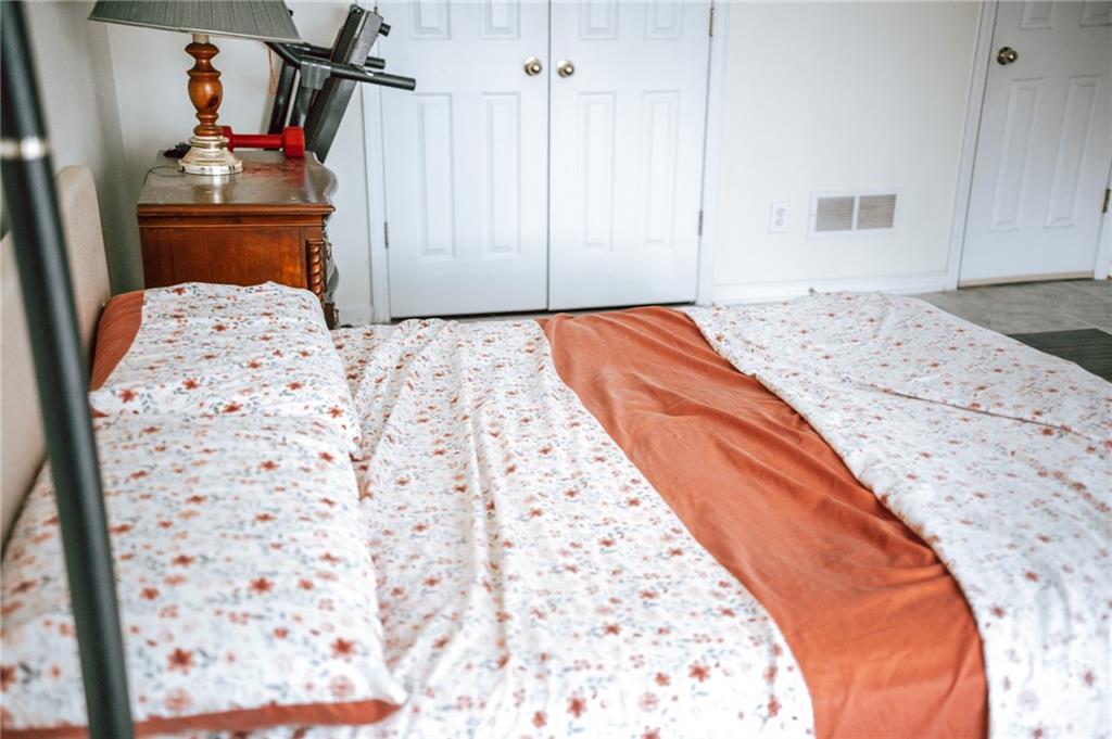 2932 Sunset View Circle Suwanee, GA 30024 - Photo 24 of 44 a bedroom with a bed and a dresser