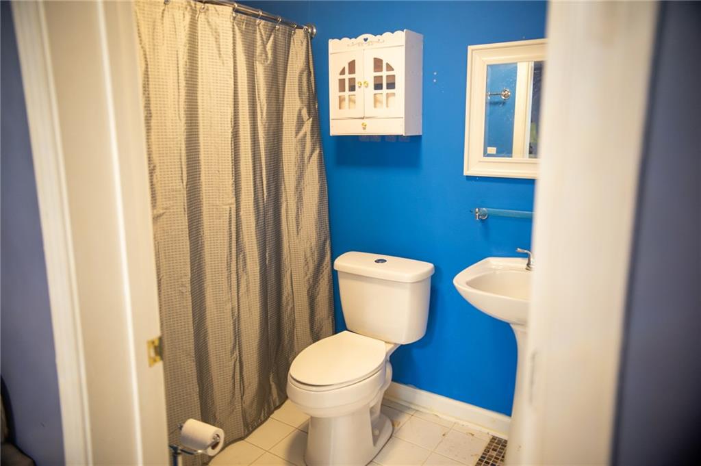 2932 Sunset View Circle Suwanee, GA 30024 - Photo 41 of 44 a bathroom with a toilet and a mirror