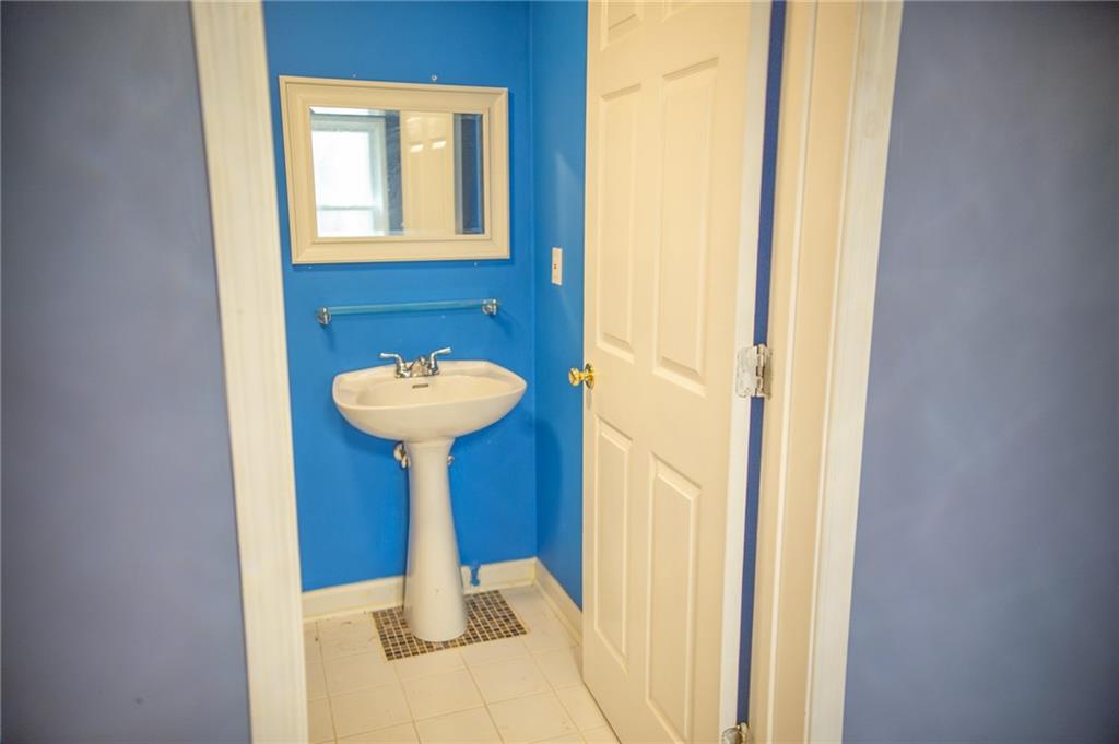 2932 Sunset View Circle Suwanee, GA 30024 - Photo 42 of 44 a bathroom with a sink and a mirror