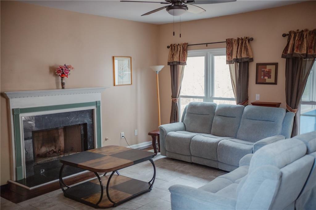 2932 Sunset View Circle Suwanee, GA 30024 - Photo 9 of 44 a living room with furniture a fireplace and a flat screen tv