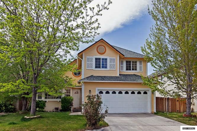 494 Len Circle Reno, NV 89511 - Photo 1 of 1 a front view of a house with a yard and garage