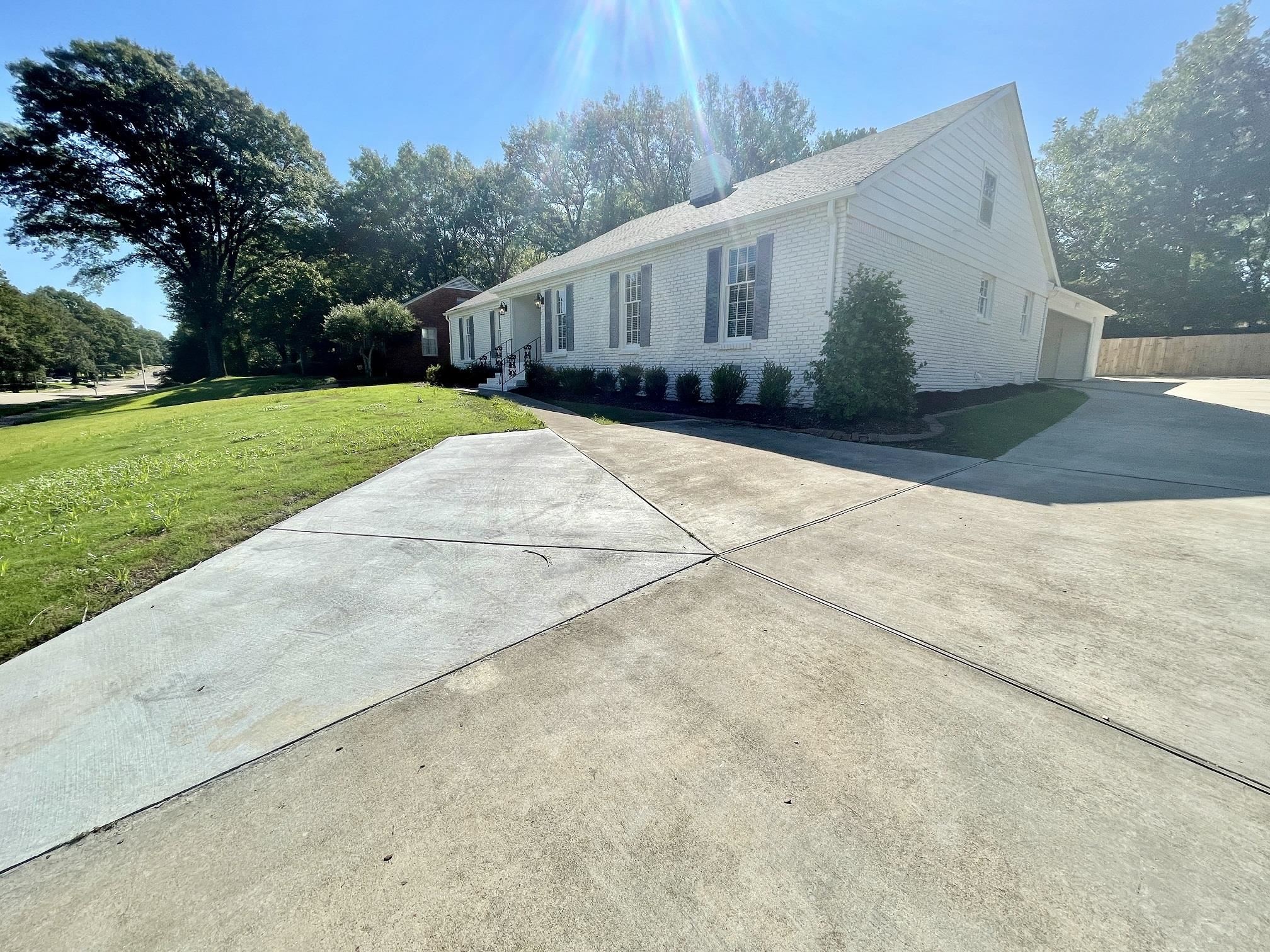 5523 Walnut Grove Road Memphis, TN 38120 - Photo 11 of 21 a view of house with backyard and trees