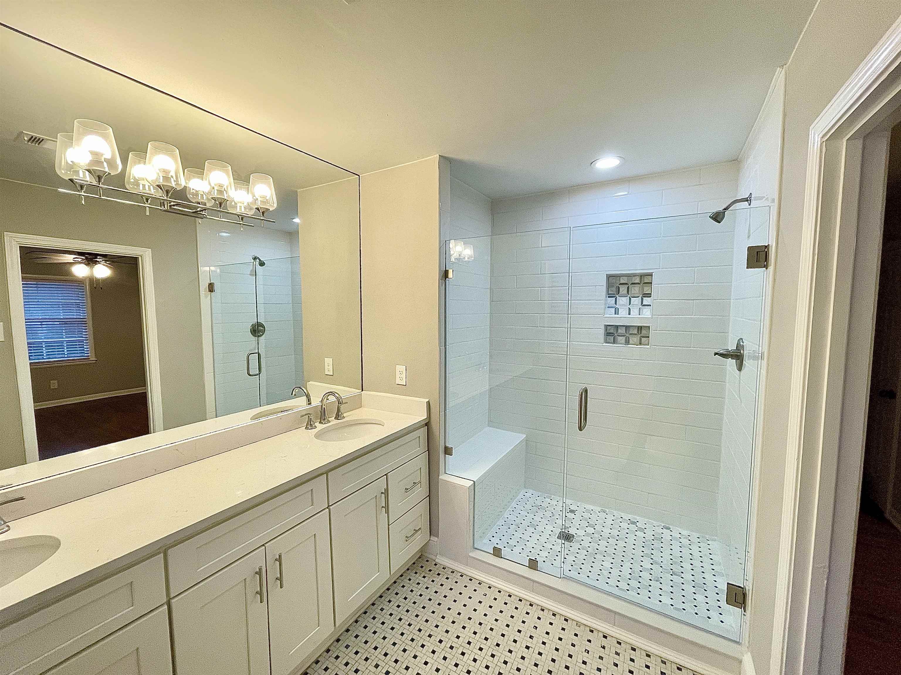 5523 Walnut Grove Road Memphis, TN 38120 - Photo 13 of 21 a bathroom with a sink a shower and a mirror