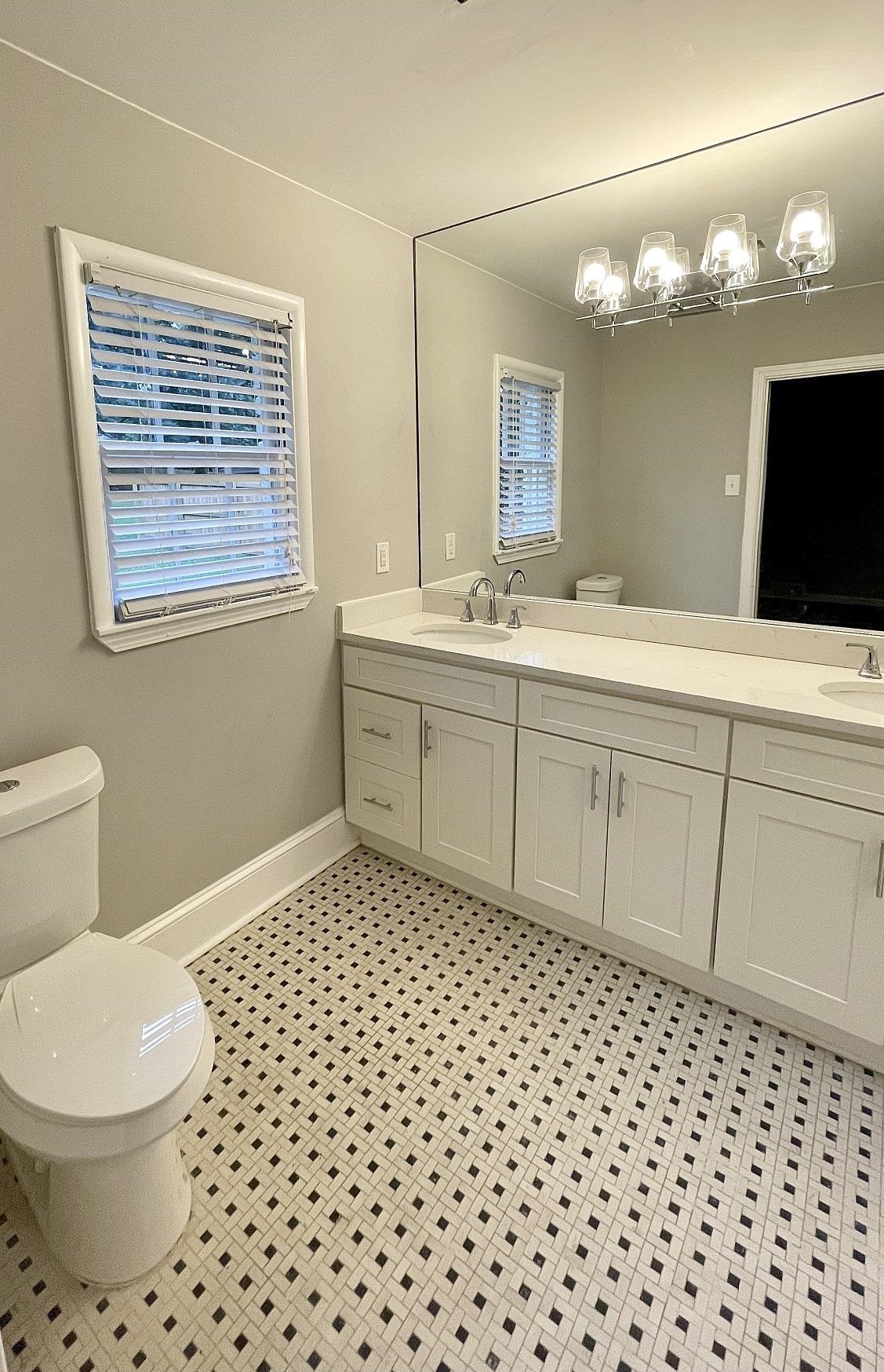 5523 Walnut Grove Road Memphis, TN 38120 - Photo 16 of 21 a bathroom with a sink a toilet and a mirror