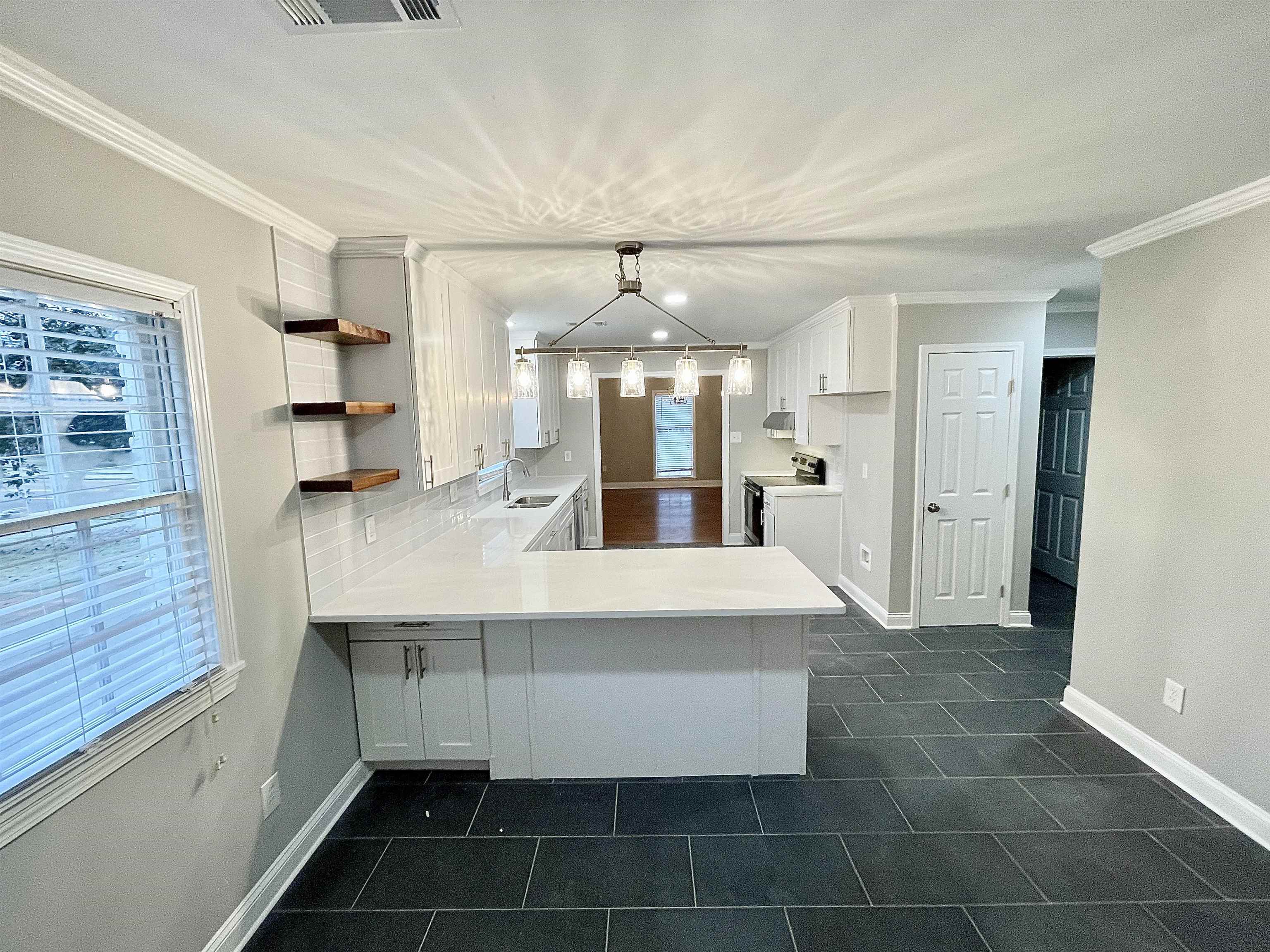 5523 Walnut Grove Road Memphis, TN 38120 - Photo 17 of 21 a large white kitchen with a sink and dishwasher a kitchen island with wooden cabinets