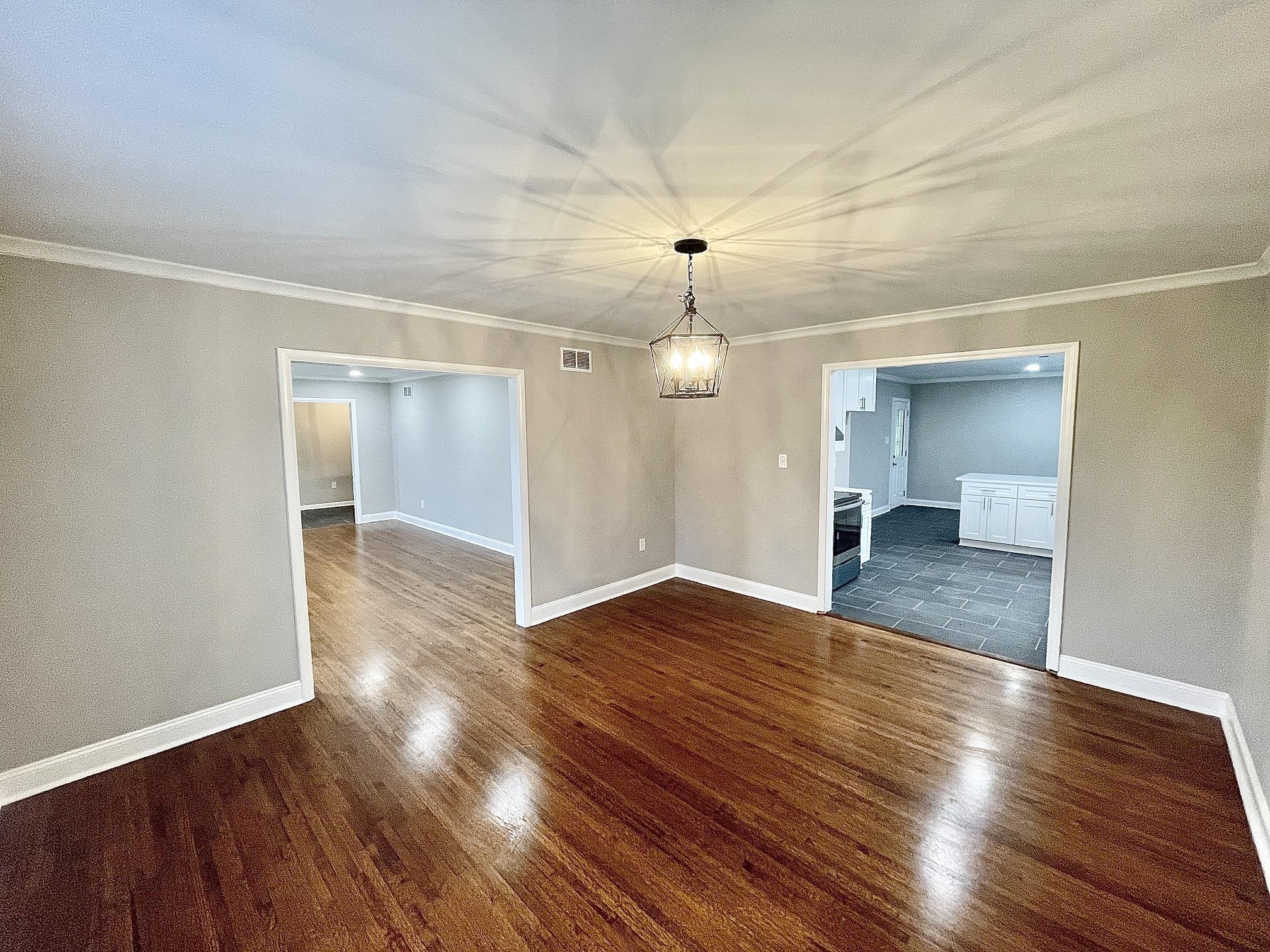 5523 Walnut Grove Road Memphis, TN 38120 - Photo 7 of 21 a view of empty room with wooden floor