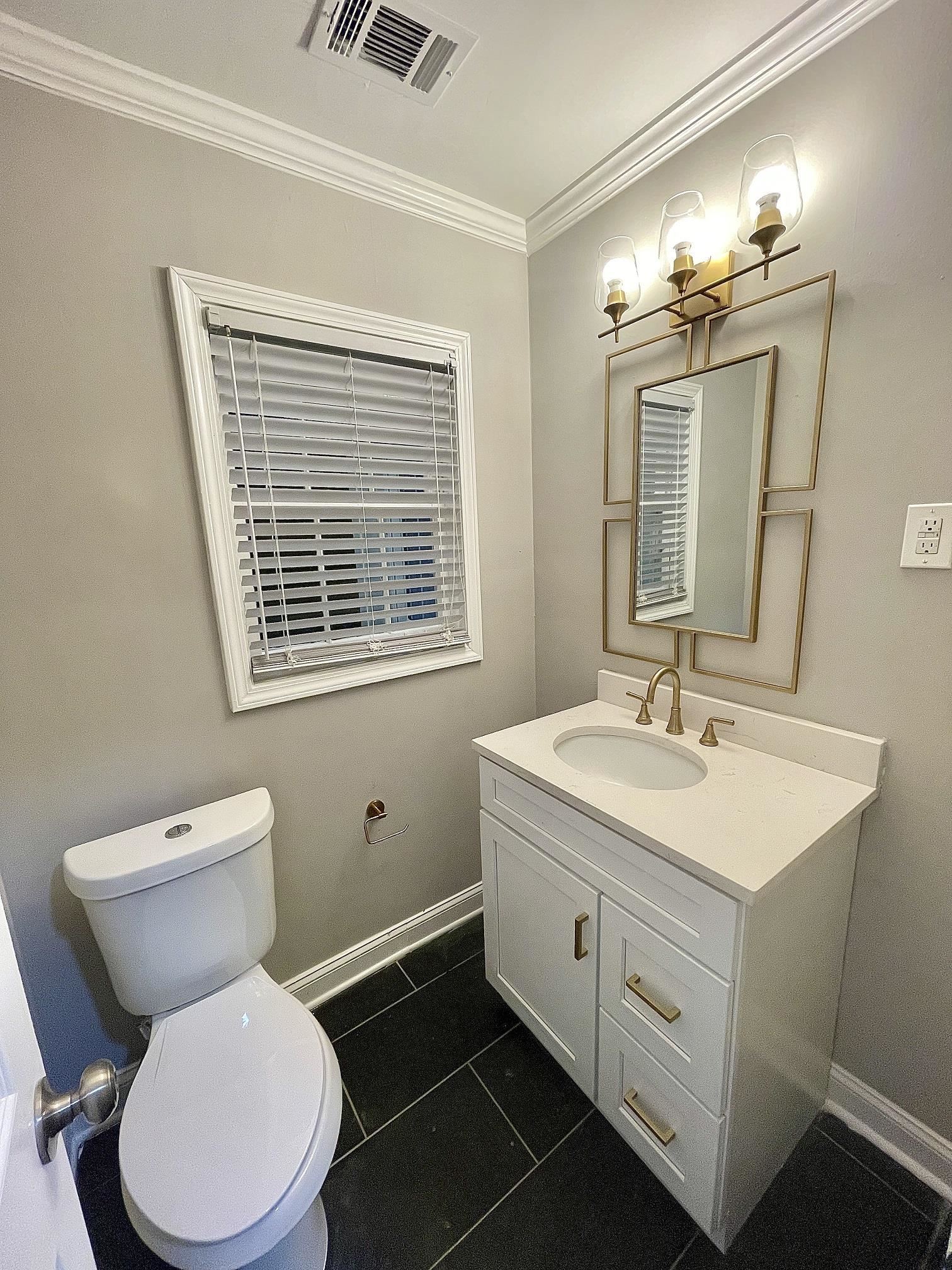 5523 Walnut Grove Road Memphis, TN 38120 - Photo 9 of 21 a bathroom with a toilet sink and mirror