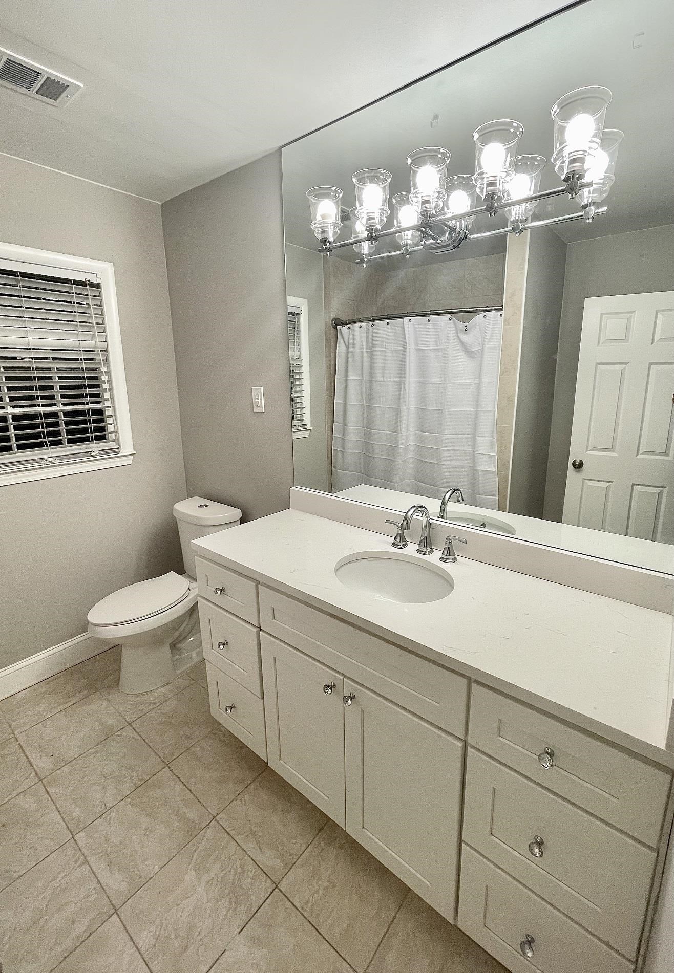 5523 Walnut Grove Road Memphis, TN 38120 - Photo 10 of 21 a bathroom with a double vanity sink mirror and toilet