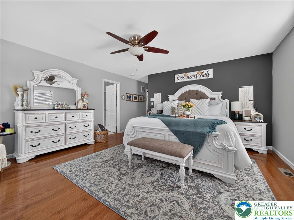 4148 Ross Road Bethlehem, PA 18020 - Photo 52 of 67 An inviting bedroom features rich hardwood flooring and a functional ceiling fan for comfort.