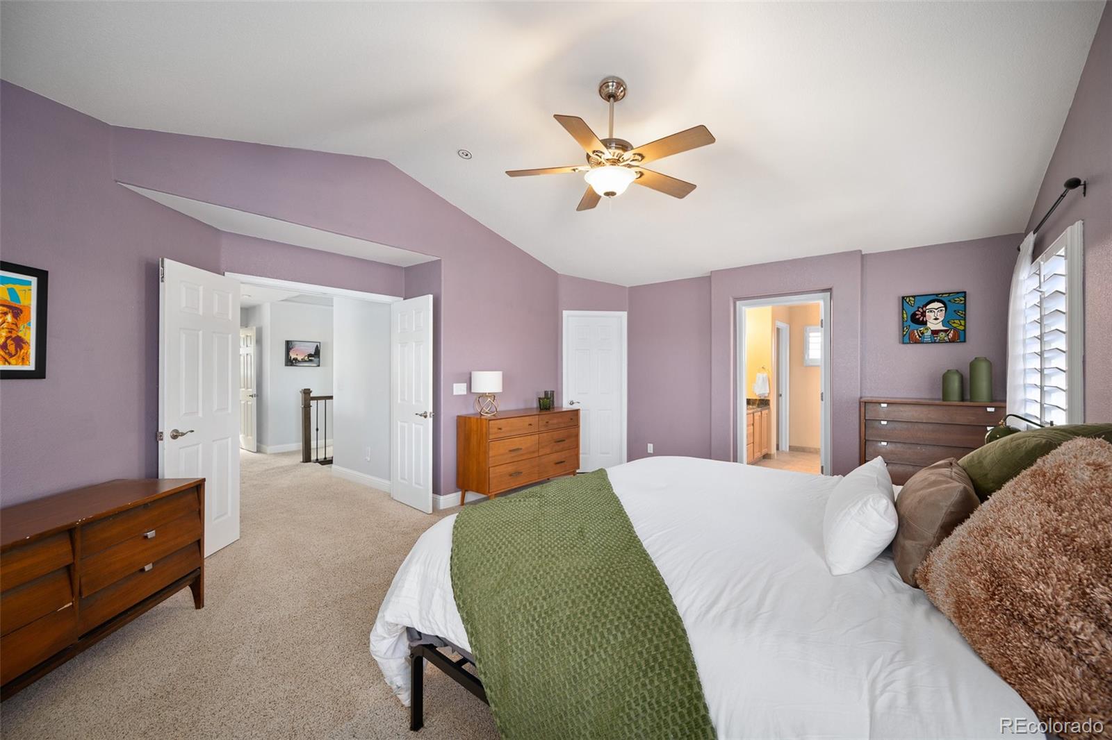 3559 Craftsbury Drive Highlands Ranch, CO 80126 - Photo 17 of 38 a bedroom with a bed and a chandelier