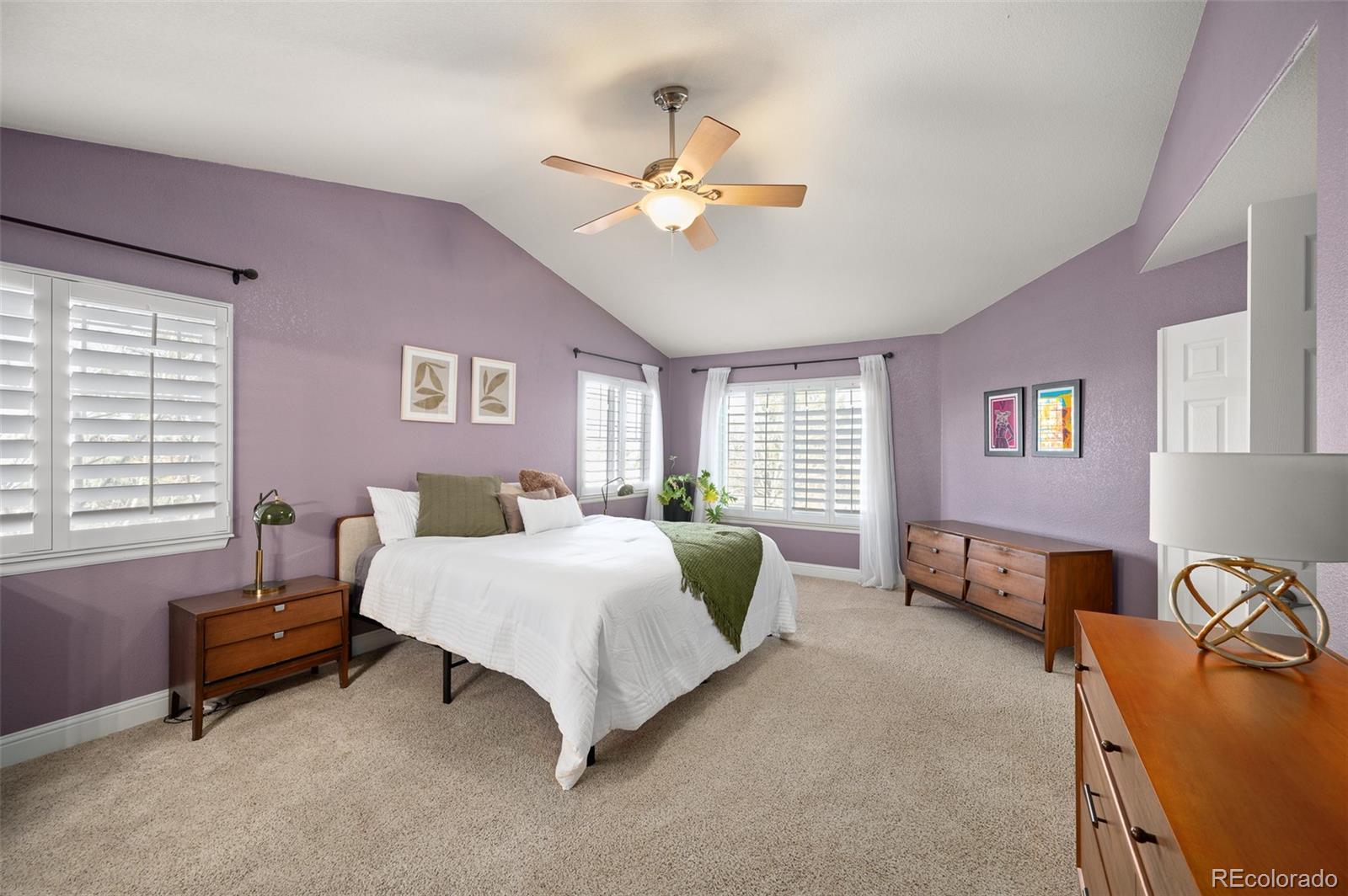3559 Craftsbury Drive Highlands Ranch, CO 80126 - Photo 18 of 38 a bedroom with a bed and a chandelier