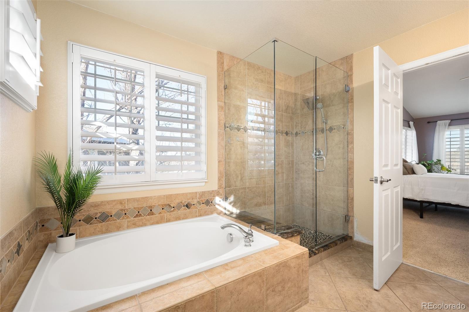 3559 Craftsbury Drive Highlands Ranch, CO 80126 - Photo 20 of 38 a bathroom with a tub a sink and a shower