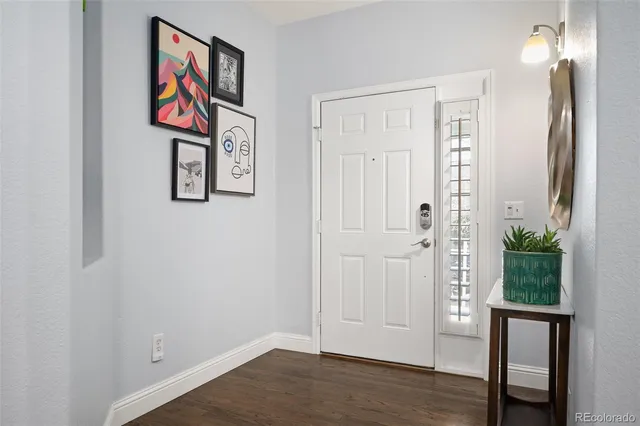 a view of a hallway with wooden floor and entryway
