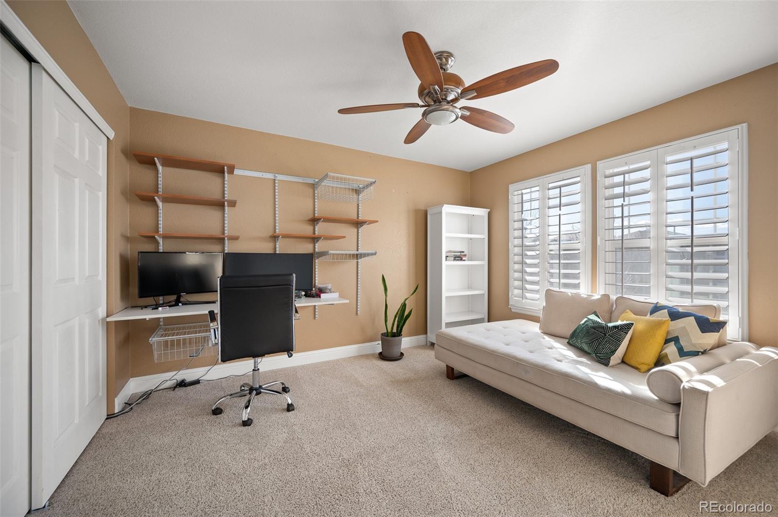 3559 Craftsbury Drive Highlands Ranch, CO 80126 - Photo 21 of 38 a living room with furniture gym equipment and a ceiling fan