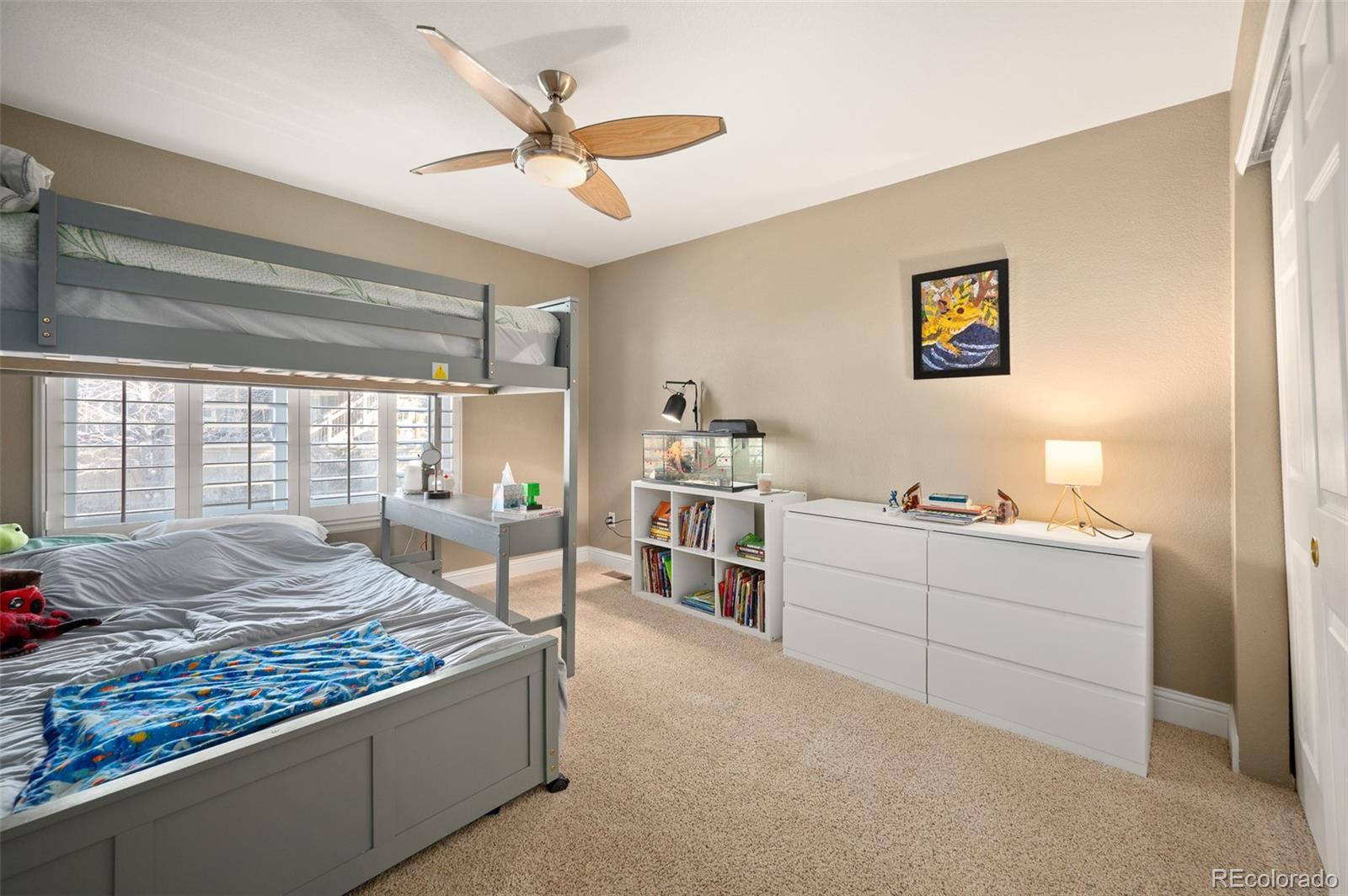3559 Craftsbury Drive Highlands Ranch, CO 80126 - Photo 22 of 38 a bedroom with a bed and a large window