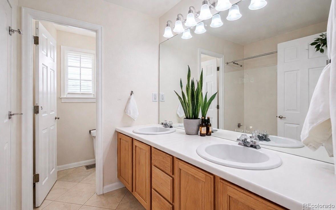 3559 Craftsbury Drive Highlands Ranch, CO 80126 - Photo 23 of 38 a bathroom with a sink double vanity and a mirror