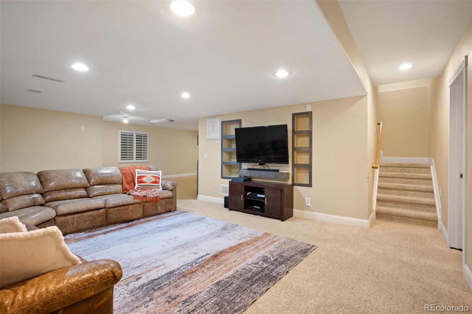 3559 Craftsbury Drive Highlands Ranch, CO 80126 - Photo 25 of 38 a living room with furniture and a flat screen tv