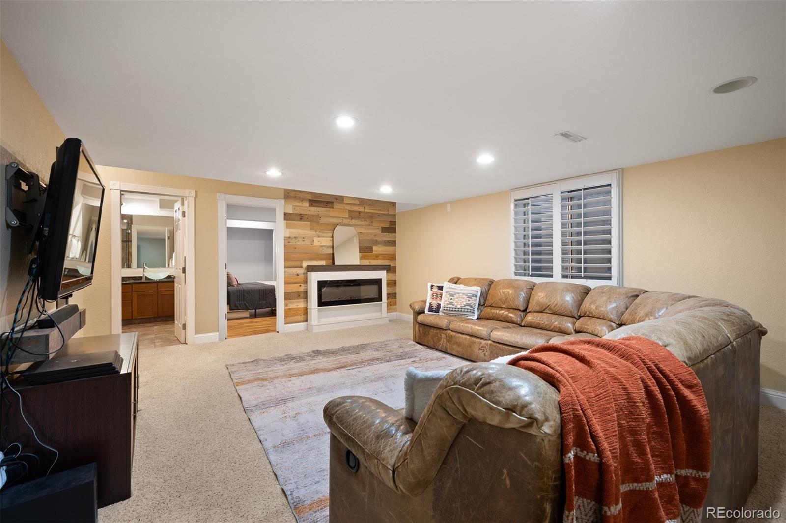 3559 Craftsbury Drive Highlands Ranch, CO 80126 - Photo 26 of 38 a living room with furniture and a flat screen tv