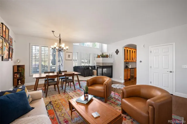 a living room with furniture a chandelier and a flat screen tv