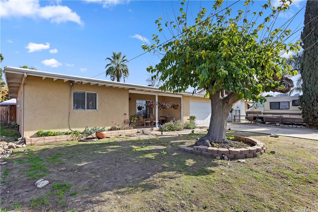 1358 Opal Avenue Mentone, CA 92359 - Photo 4 of 28 a front view of a house with garden