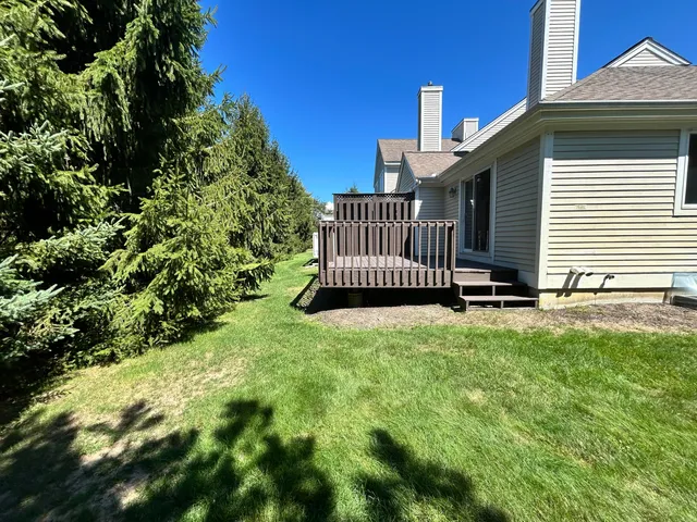 a view of balcony with wooden floor and fence