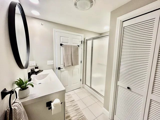 a bathroom with a sink mirror and toilet