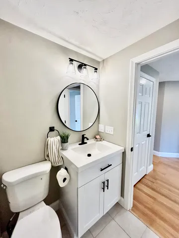 a bathroom with a sink toilet and shower