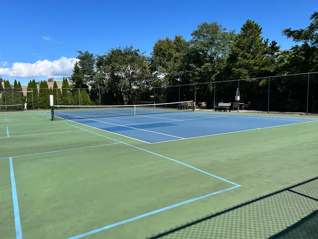 a view of a yard with street from a ceiling fan