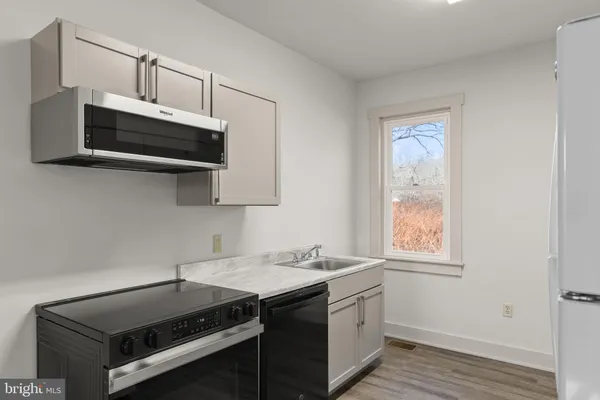 a kitchen that has a sink and a stove