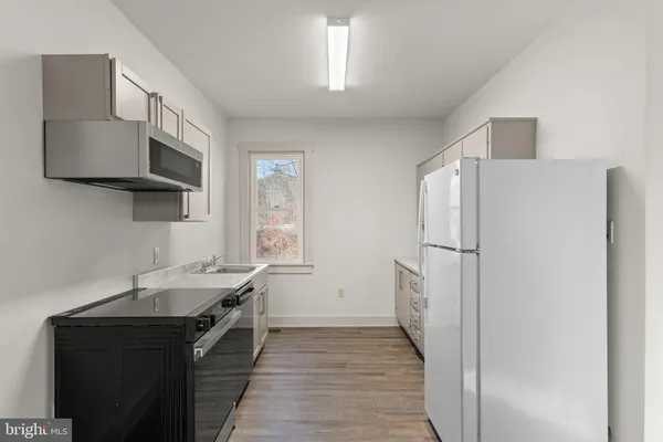 a kitchen with a sink appliances and cabinets