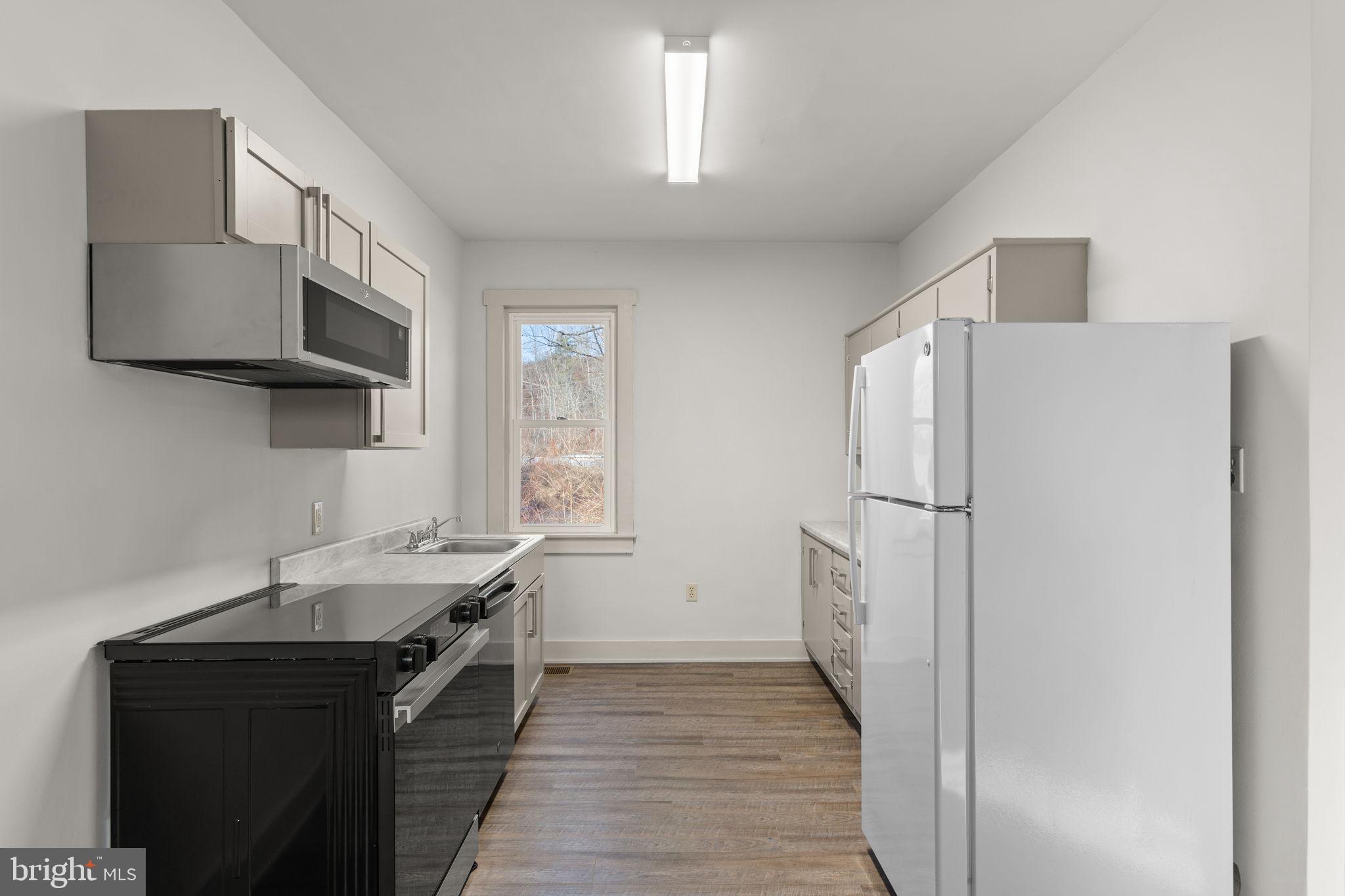 1586 Schwaben Creek Road Dornsife, PA 17823 - Photo 13 of 39 a kitchen with a sink appliances and cabinets