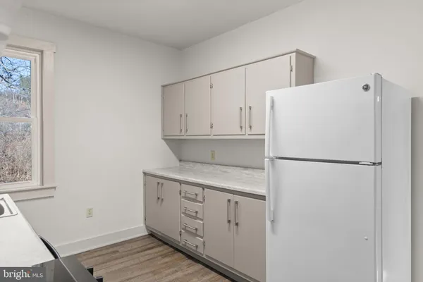 a white refrigerator freezer sitting inside of a kitchen