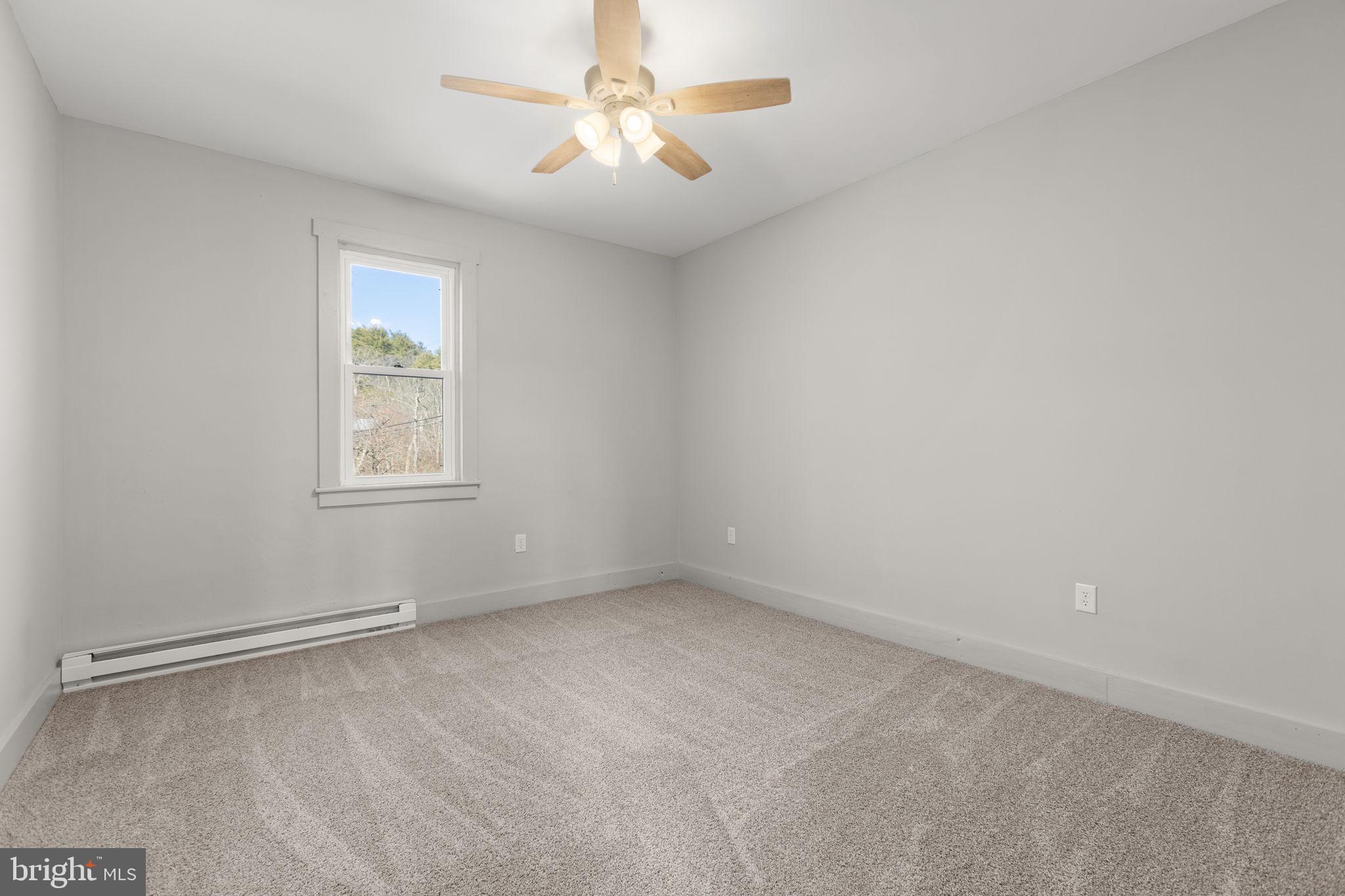 1586 Schwaben Creek Road Dornsife, PA 17823 - Photo 26 of 39 an empty room with a window and a fan